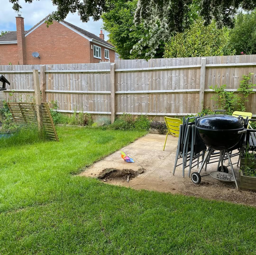 Cracked concrete BBQ pad and open boundary before the rebuild