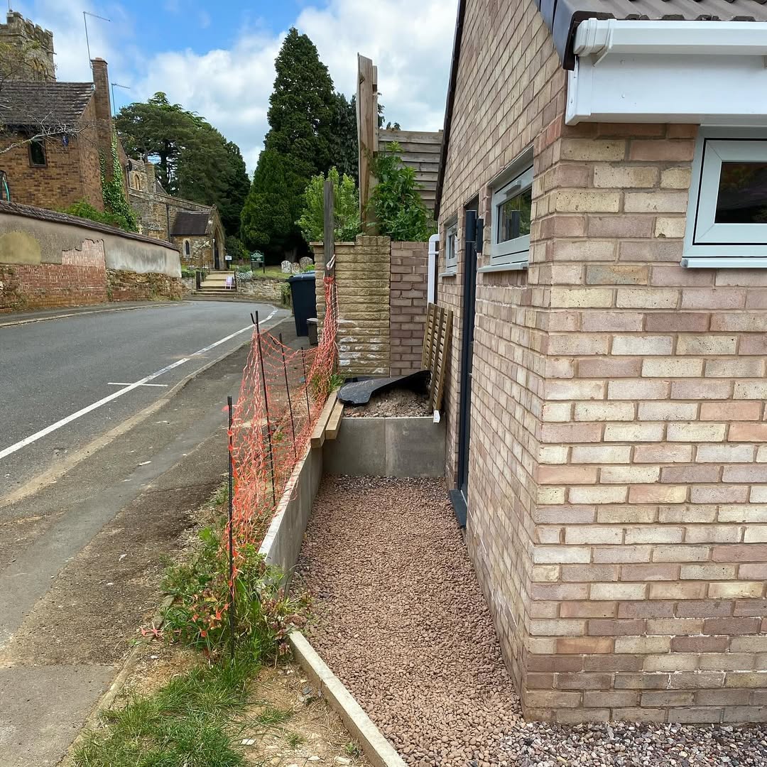 Side of the bungalow open to the road with only orange safety mesh