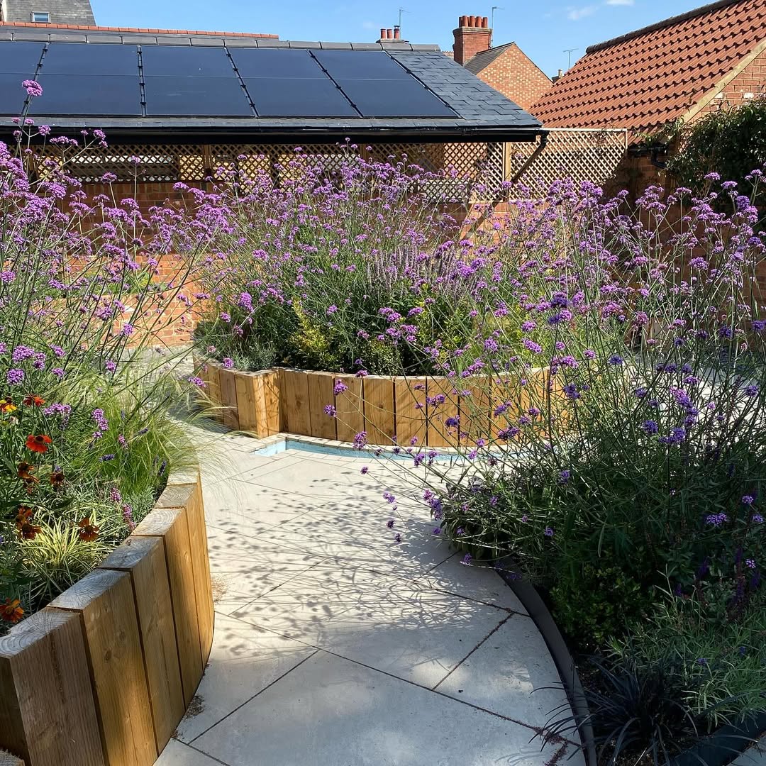 Verbena and grasses spilling over sleeper edges in summer