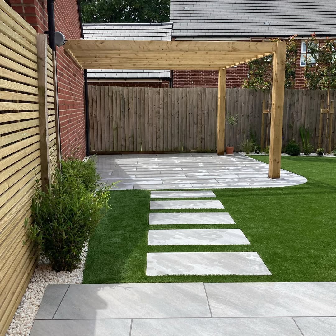 Porcelain stepping-stone walkway across artificial lawn